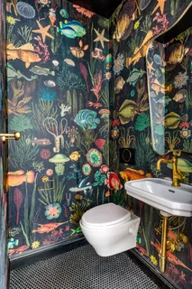 a kitchen with a table chairs sink and cabinets