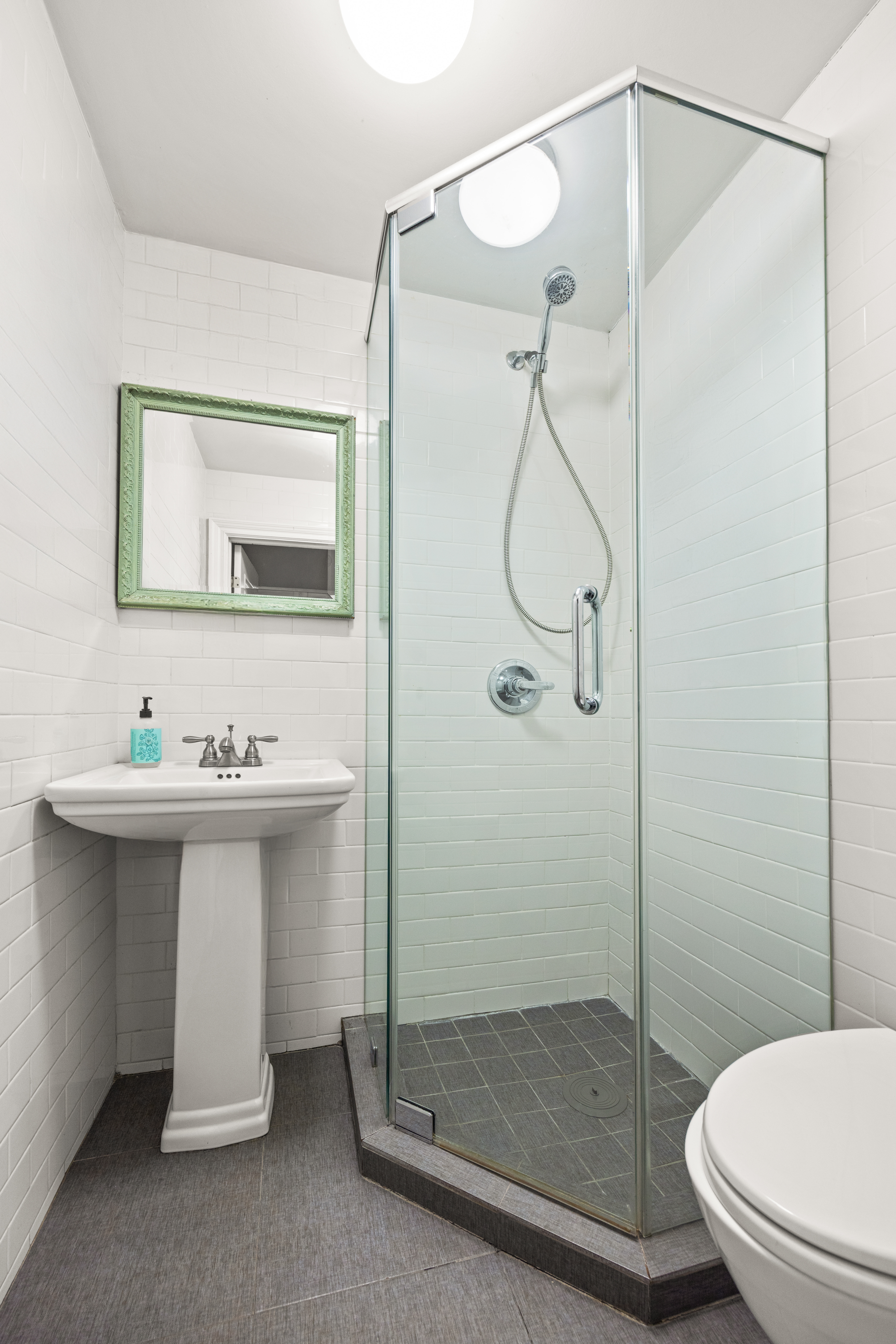 136 East 56th Street, Unit 10JK Manhattan, NY 10022 - Photo 9 of 12 a bathroom with a sink toilet and shower