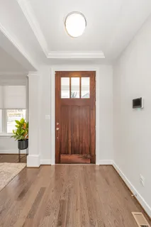 a very nice looking dining room with furniture window and wooden floor