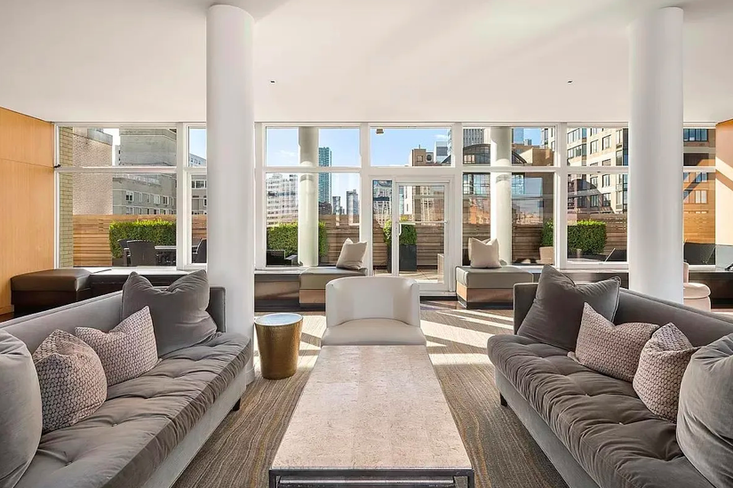 200 East 66th Street, Unit A407 Manhattan, NY 10065 - Photo 17 of 24 a living room with furniture and large windows