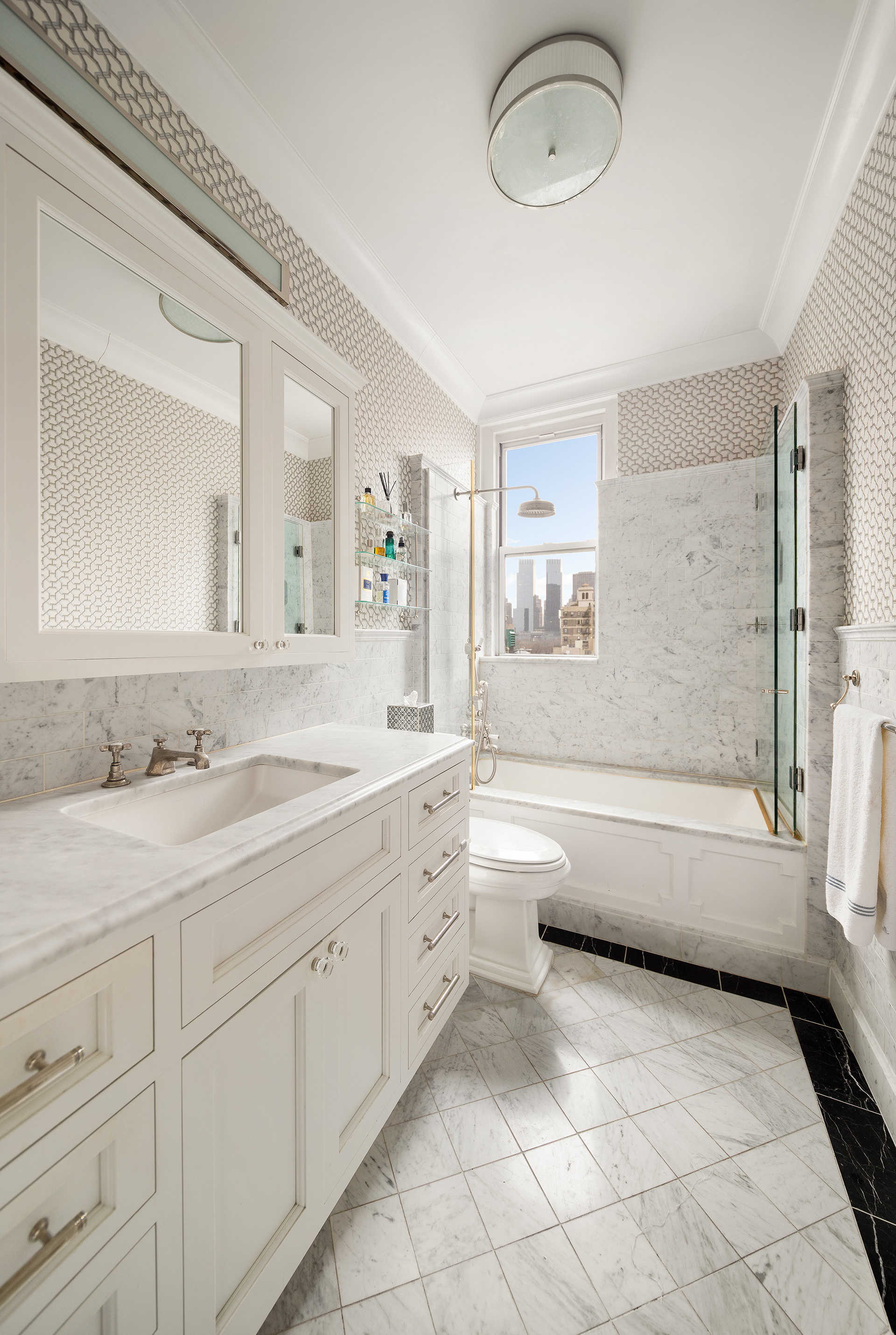 570 Park Avenue, Unit 10D Manhattan, NY 10065 - Photo 11 of 17 a bathroom with a granite countertop sink a toilet and a bathtub