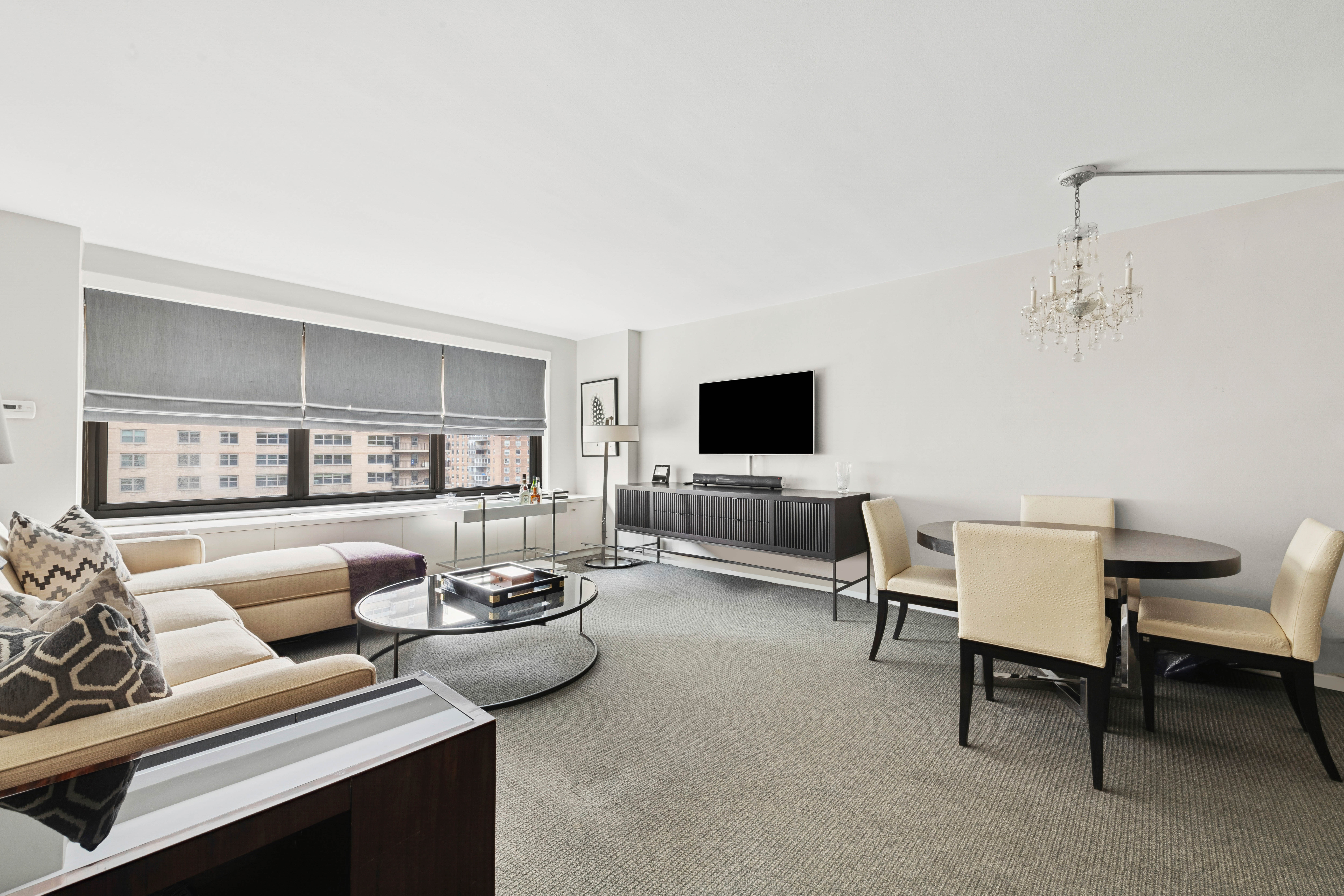 180 West End Avenue, Unit 14G Manhattan, NY 10023 - Photo 2 of 9 a living room with furniture and a flat screen tv
