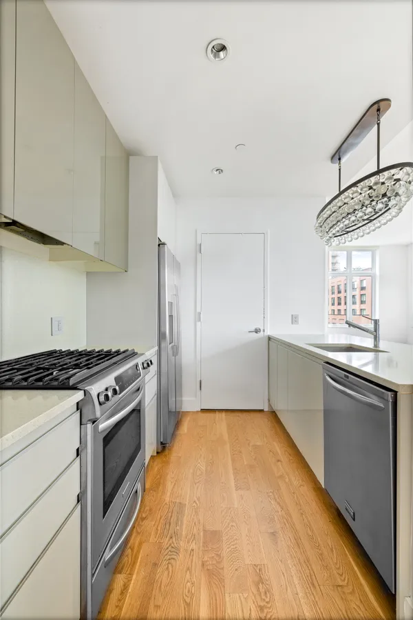 a kitchen with a stove a sink and a refrigerator