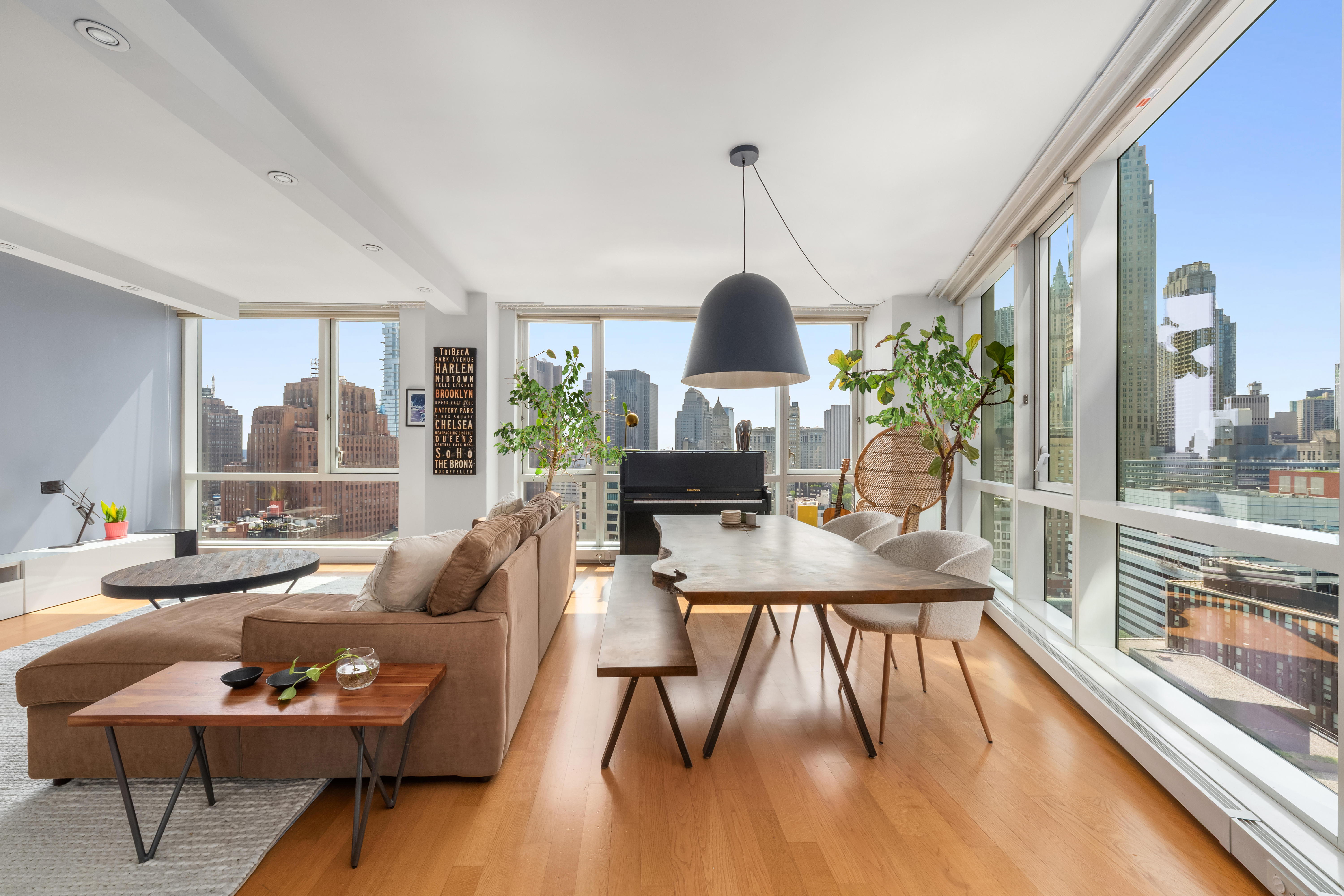 200 Chambers Street, Unit 25F Manhattan, NY 10007 - Photo 4 of 13 a living room with furniture floor to ceiling window and wooden floor