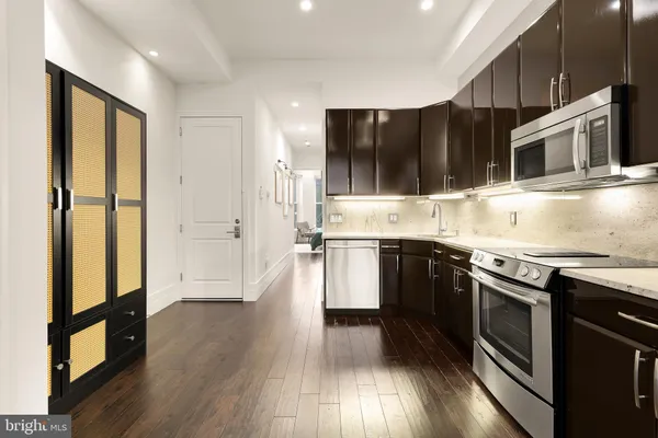 a kitchen with stainless steel appliances a stove sink and refrigerator