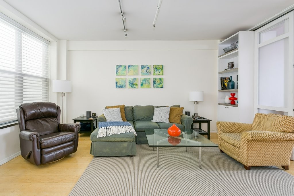 453 Washington Street, Unit 5D Boston, MA 02111 - Photo 2 of 17 a living room with furniture and a large window