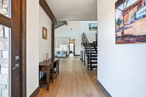 a view of entryway and hall with wooden floor