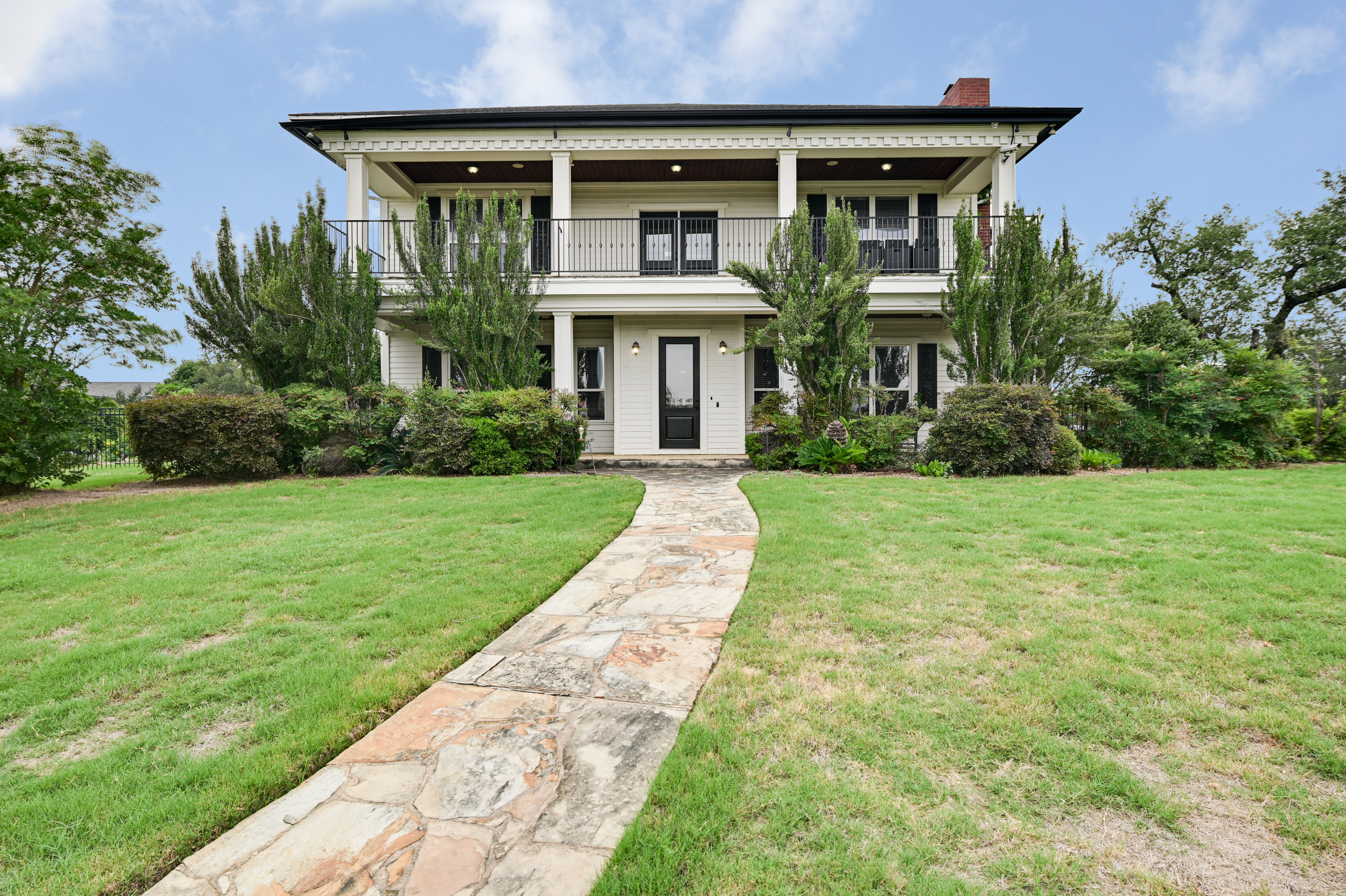 a front view of house with yard and green space