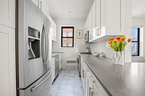 a kitchen with stainless steel appliances granite countertop a refrigerator a sink and a stove