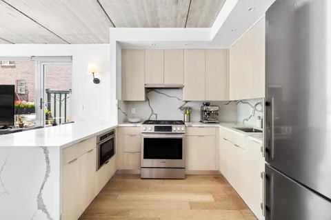 a kitchen with stainless steel appliances white cabinets and a sink