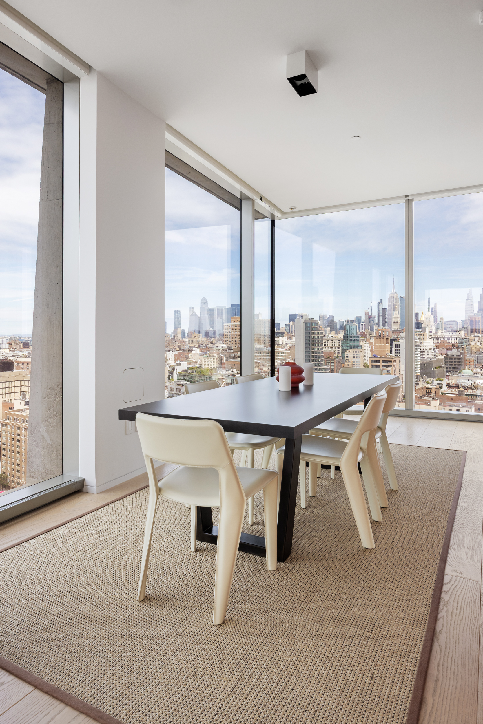 215 Chrystie Street, Unit 29W Manhattan, NY 10002 - Photo 7 of 24 a dining room with furniture and a floor to ceiling window