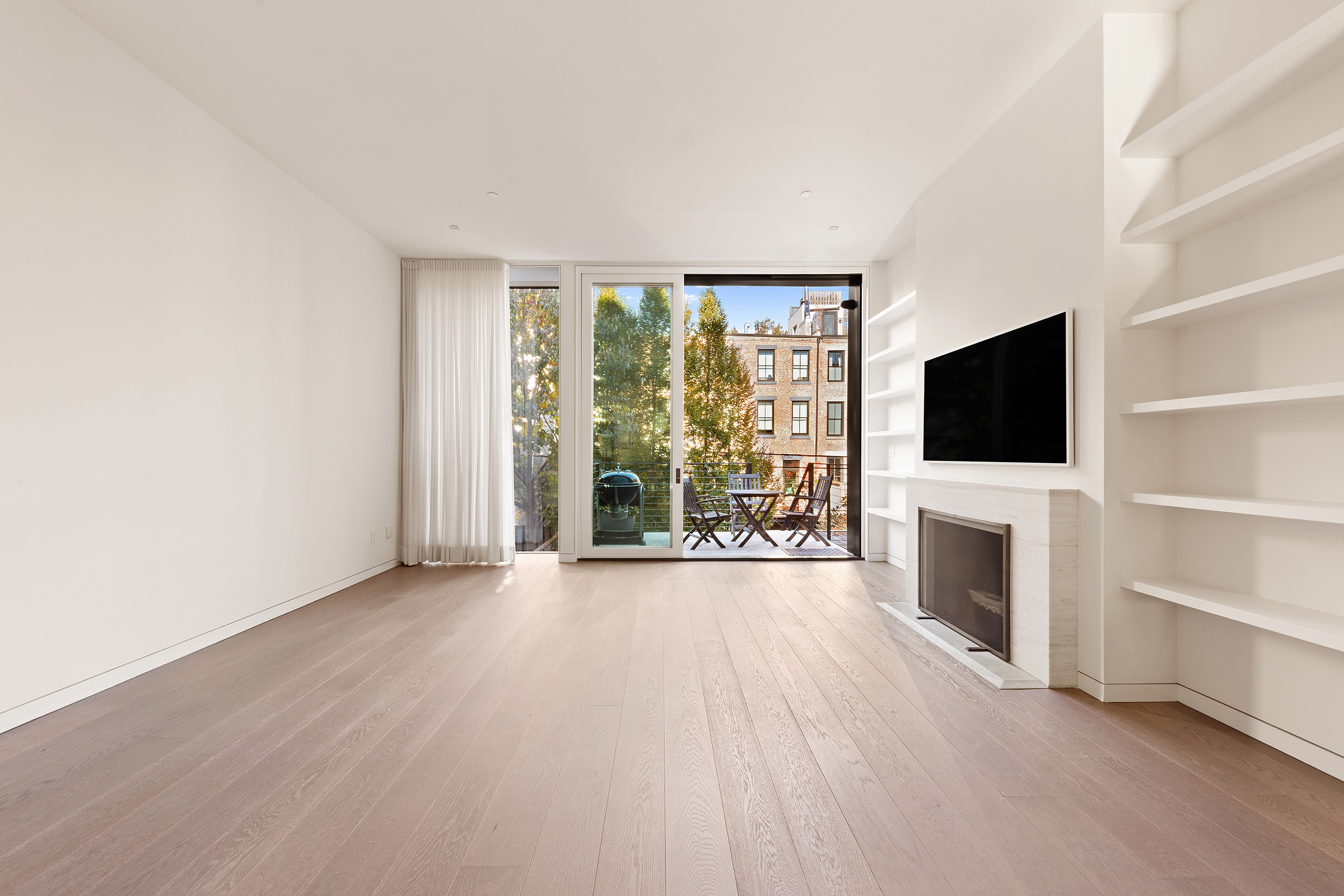 369 Union Street Brooklyn, NY 11231 - Photo 4 of 21 an empty room with furniture a flat screen tv and a fireplace