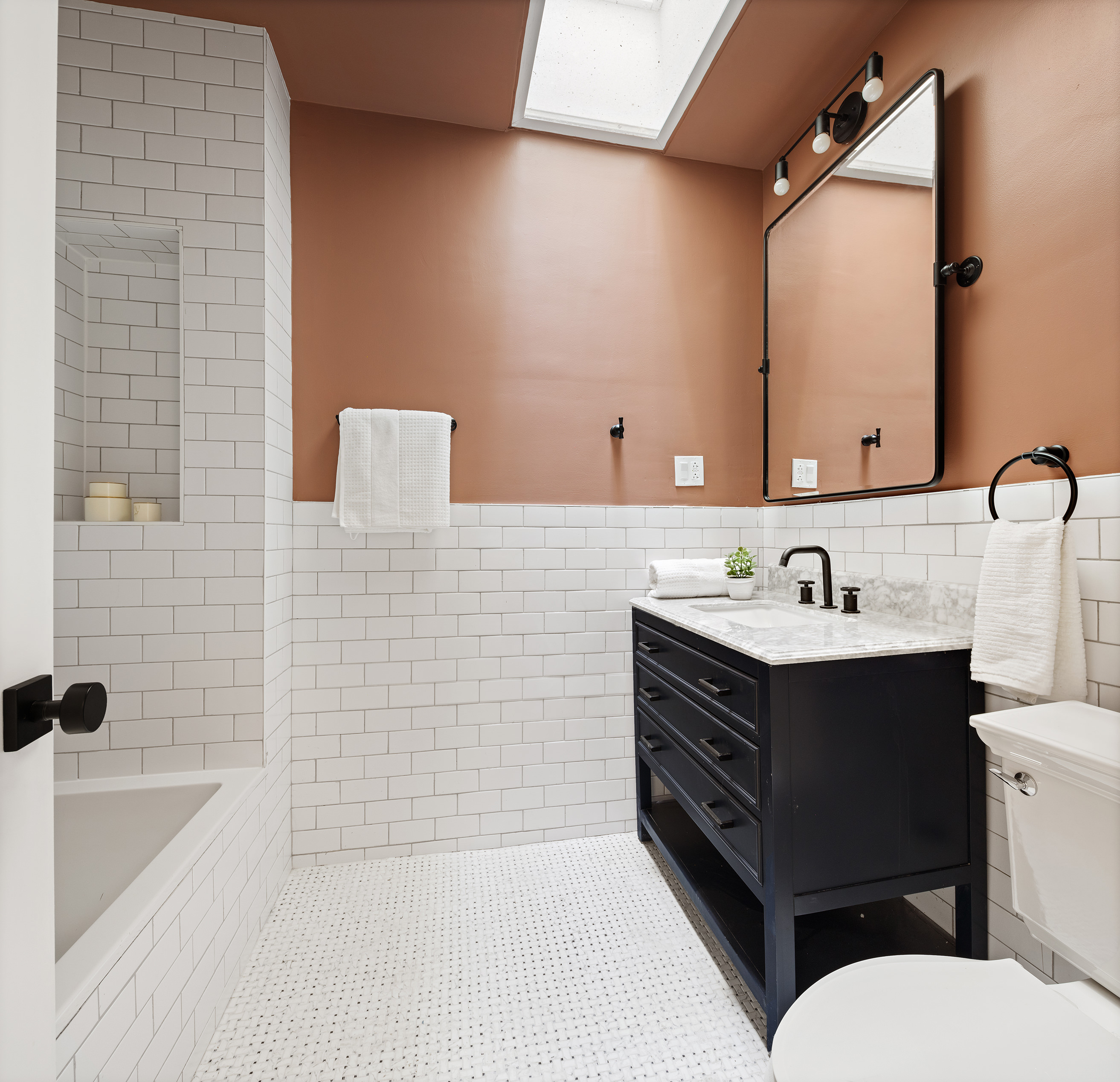 259 New York Avenue Brooklyn, NY 11216 - Photo 16 of 25 a bathroom with a sink a toilet a mirror and bathtub