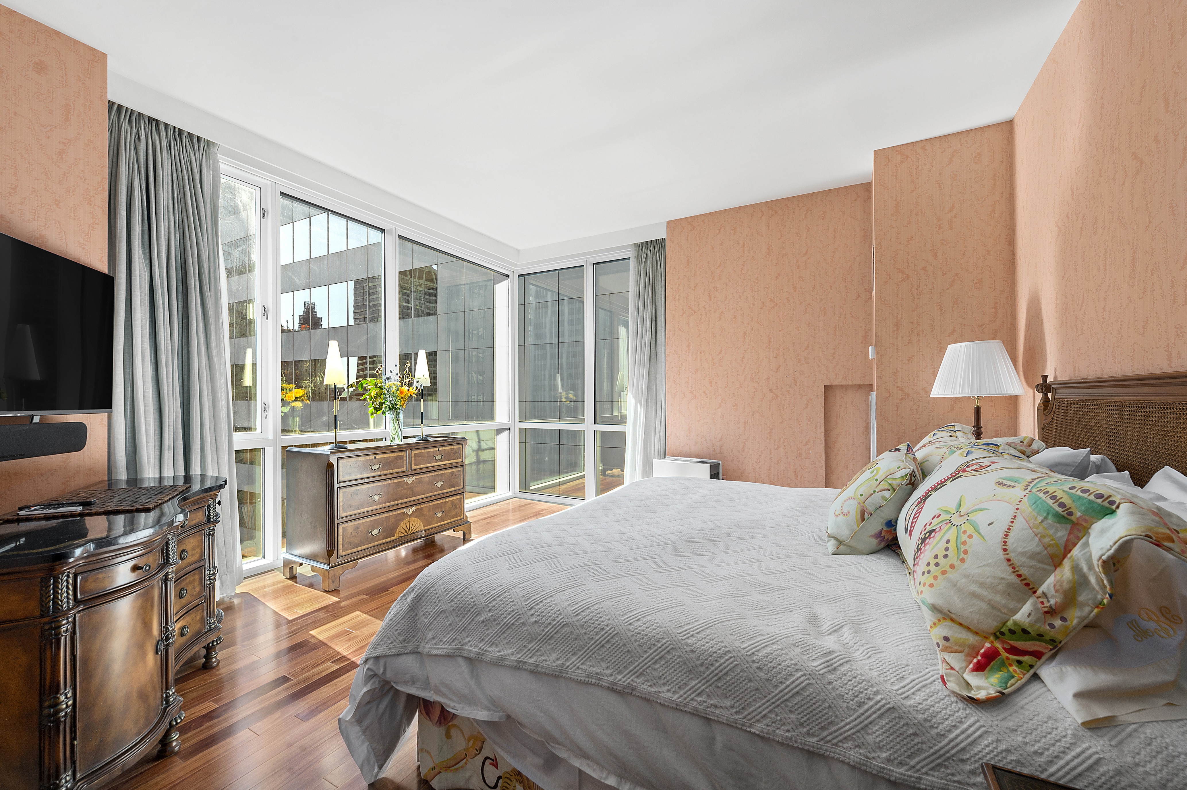 60 East 55th Street, Unit 40B Manhattan, NY 10022 - Photo 2 of 12 a bedroom with a bed and large windows