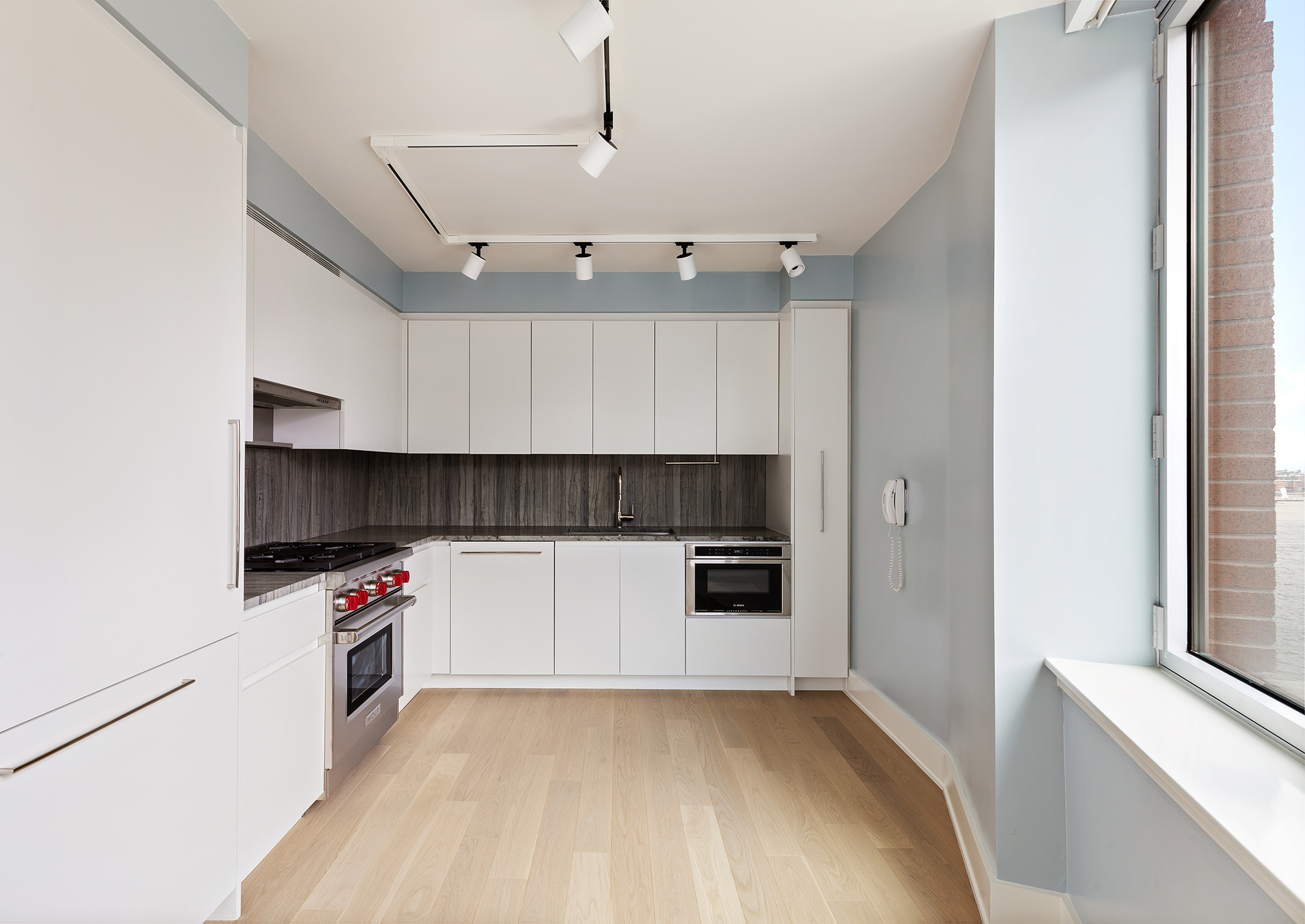 20 River Terrace, Unit 22A Manhattan, NY 10282 - Photo 2 of 27 a kitchen with a white cabinets and white appliances