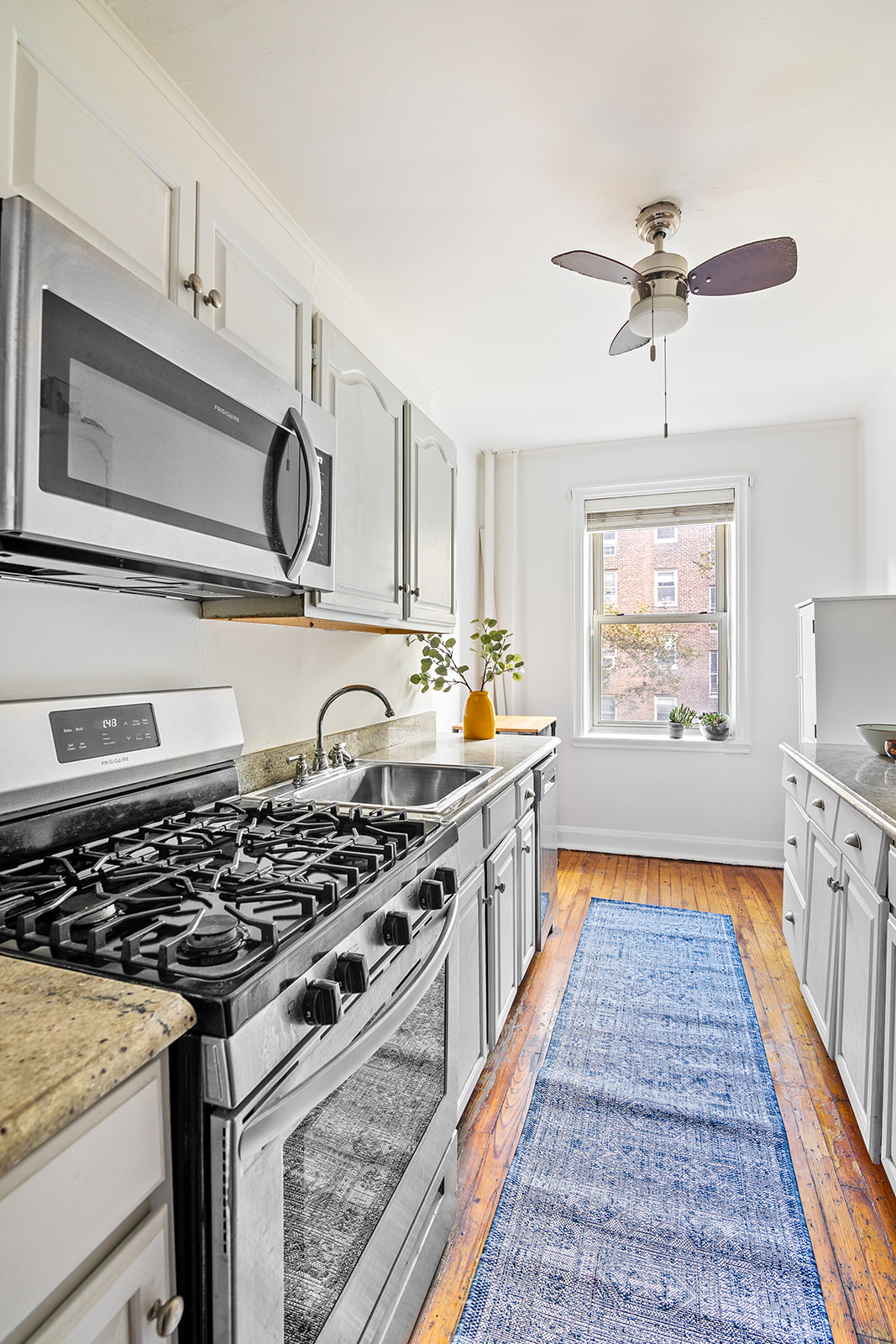 48-19 43rd Street, Unit 4A Queens, NY 11377 - Photo 4 of 8 a kitchen with stainless steel appliances granite countertop a stove and a sink