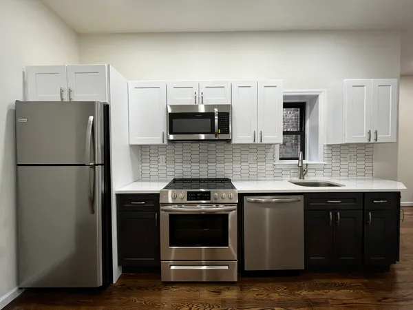 a kitchen with a sink and a refrigerator
