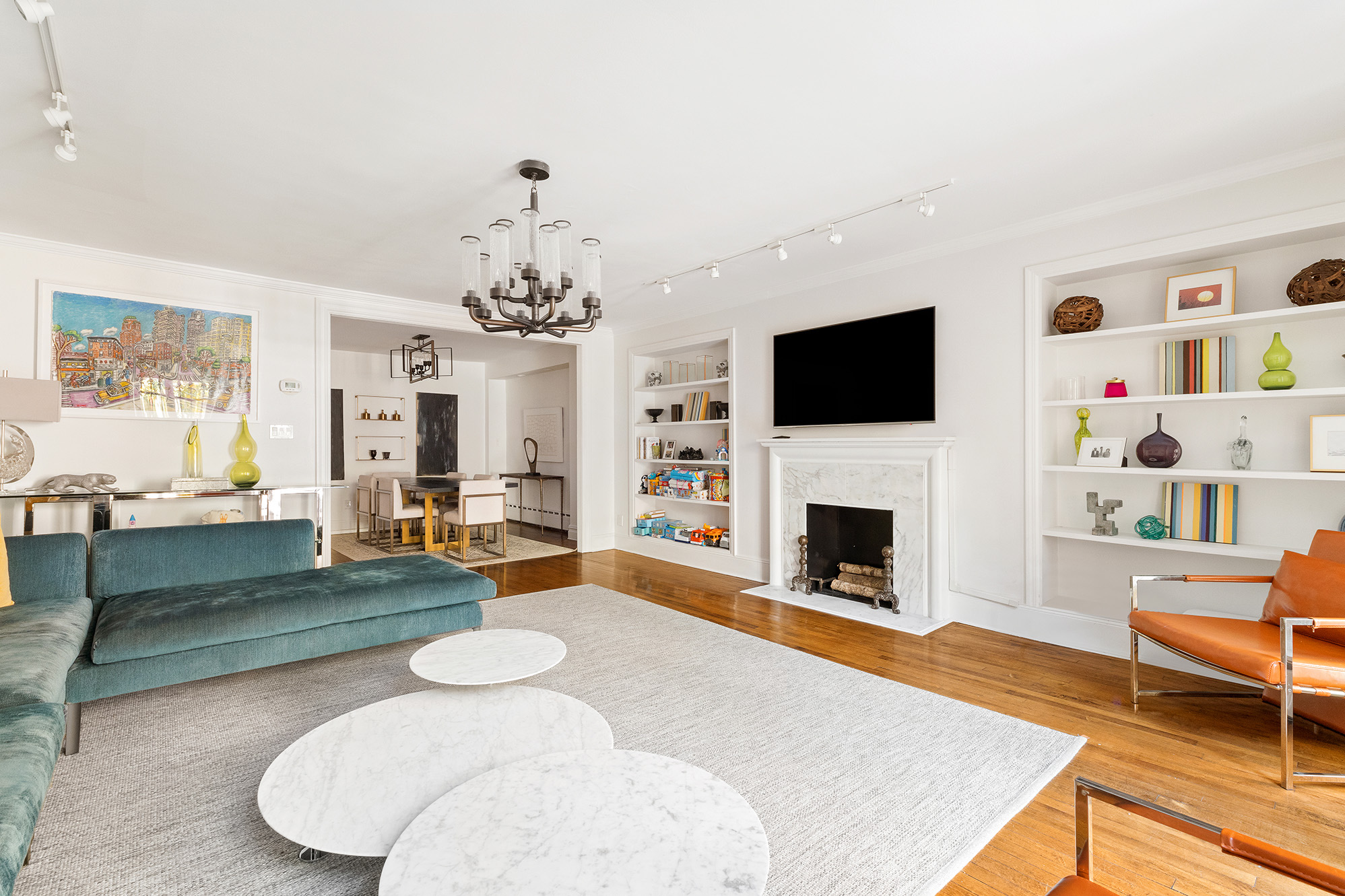 209 East 61st Street Manhattan, NY 10065 - Photo 16 of 24 a living room with fireplace furniture and a flat screen tv