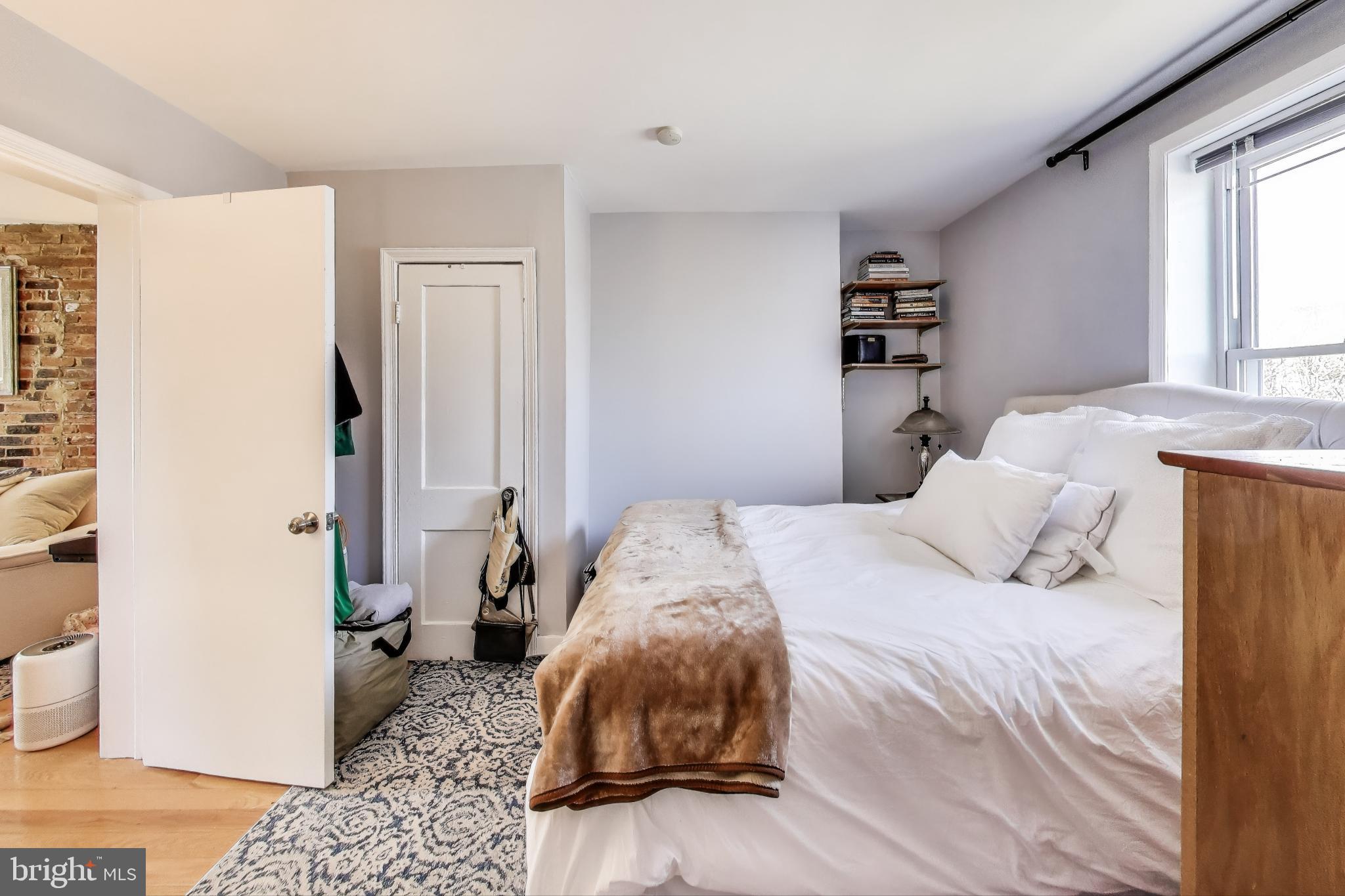 1317 Corcoran Street Northwest Washington, DC 20009 - Photo 24 of 47 a bedroom with a bed and a window
