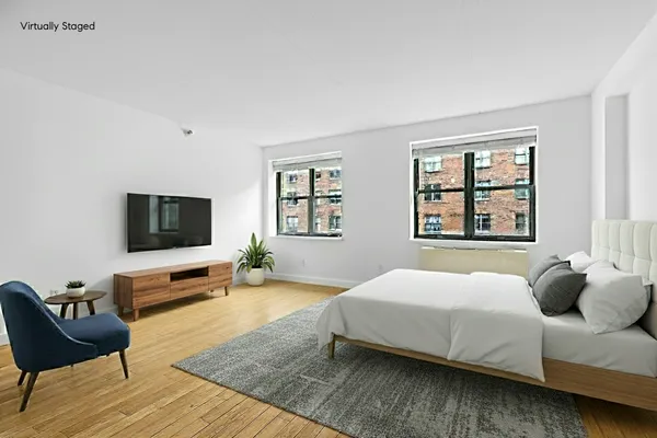 a bedroom with a bed and a couch