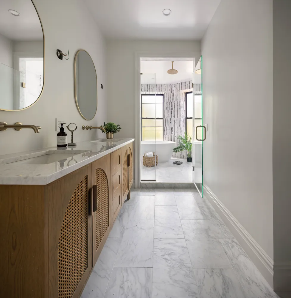 a spacious bathroom with a double vanity sink a mirror and a bathtub