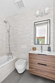 a bathroom with a sink a toilet and a bathtub