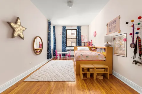 a bed room with a bed window and a table