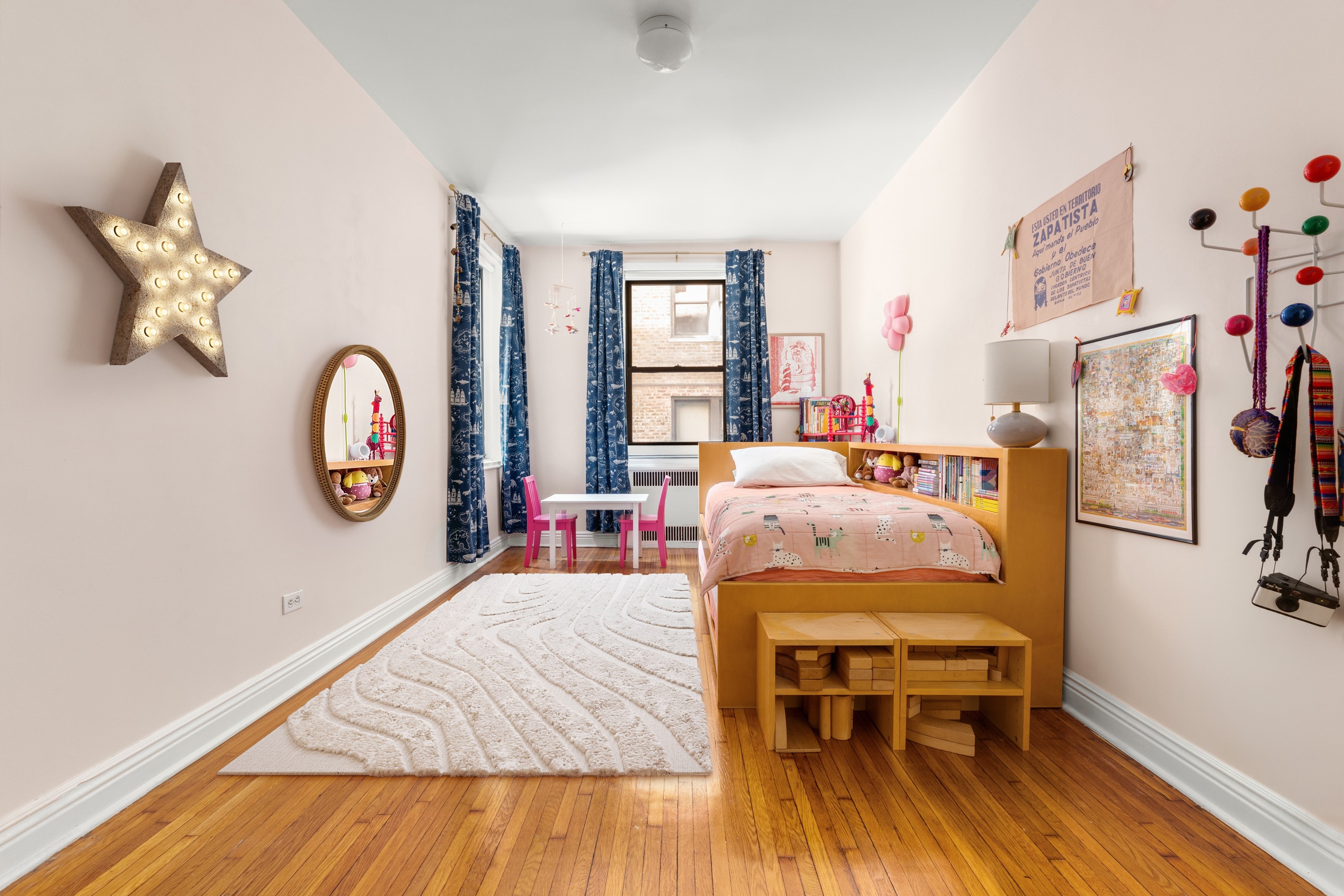657 East 26th Street, Unit 1G Brooklyn, NY 11210 - Photo 7 of 9 a bed room with a bed window and a table