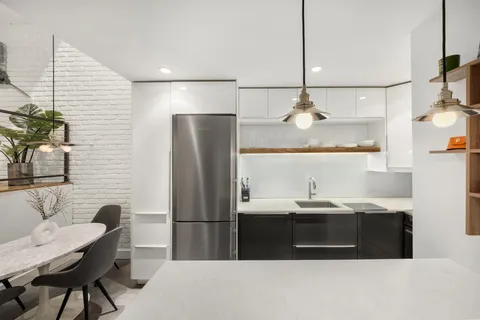 a bathroom with a sink a counter and chairs