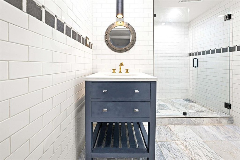 308 Clifton Place Brooklyn, NY 11216 - Photo 27 of 41 a bathroom with a sink and a mirror