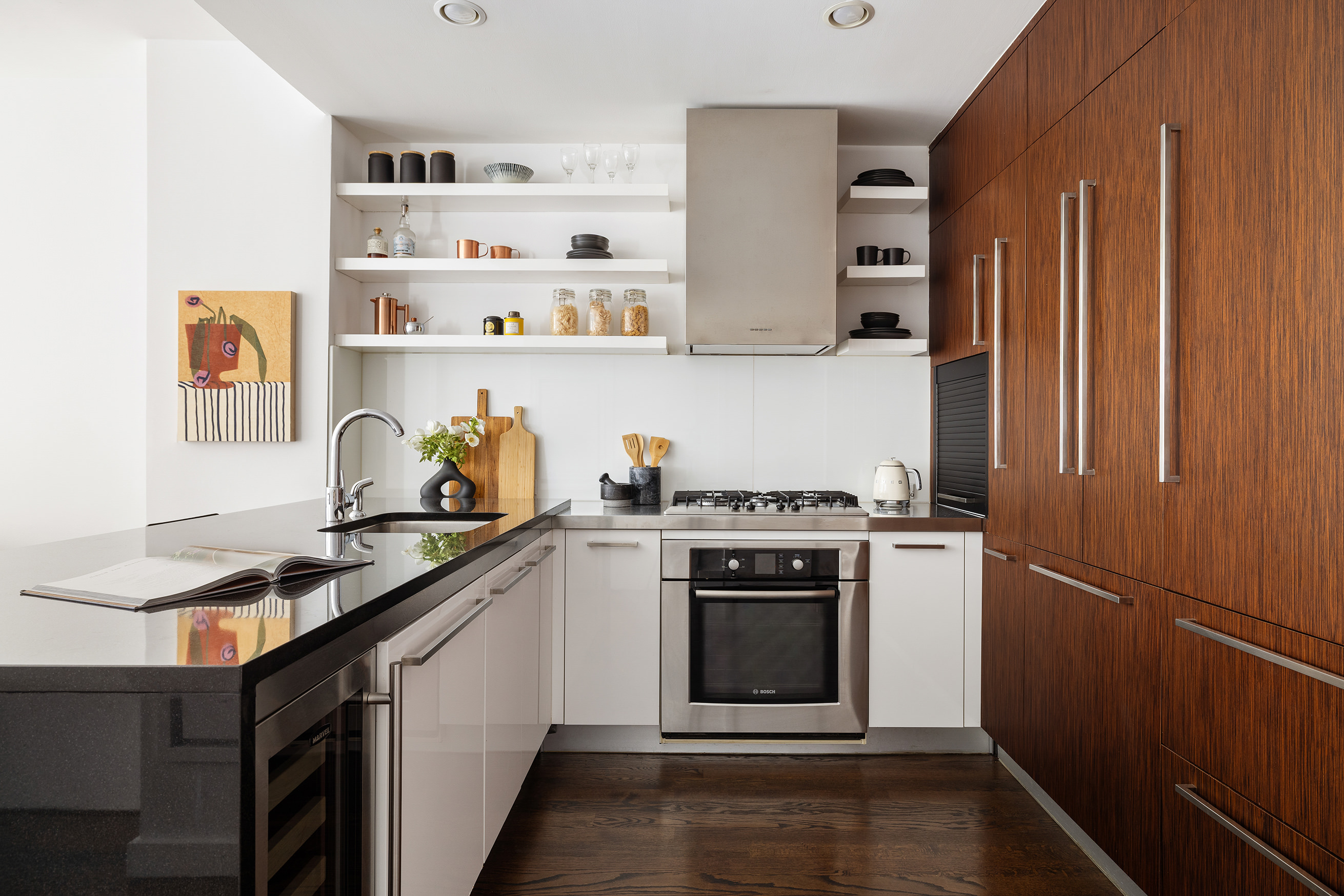 133 West 22nd Street, Unit 8C Manhattan, NY 10011 - Photo 4 of 11 a kitchen with stainless steel appliances granite countertop a stove a sink and a refrigerator