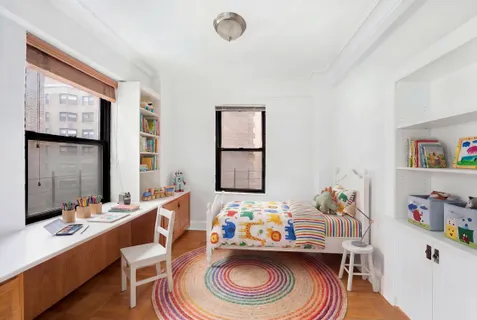a kids room with toys and a wooden floor