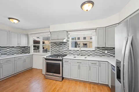 a kitchen with stainless steel appliances granite countertop a stove and a sink