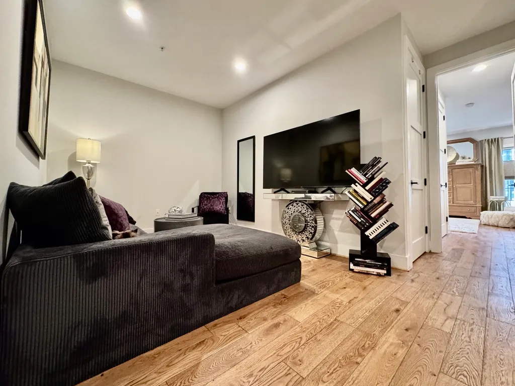 a bedroom with a bed and a flat screen tv