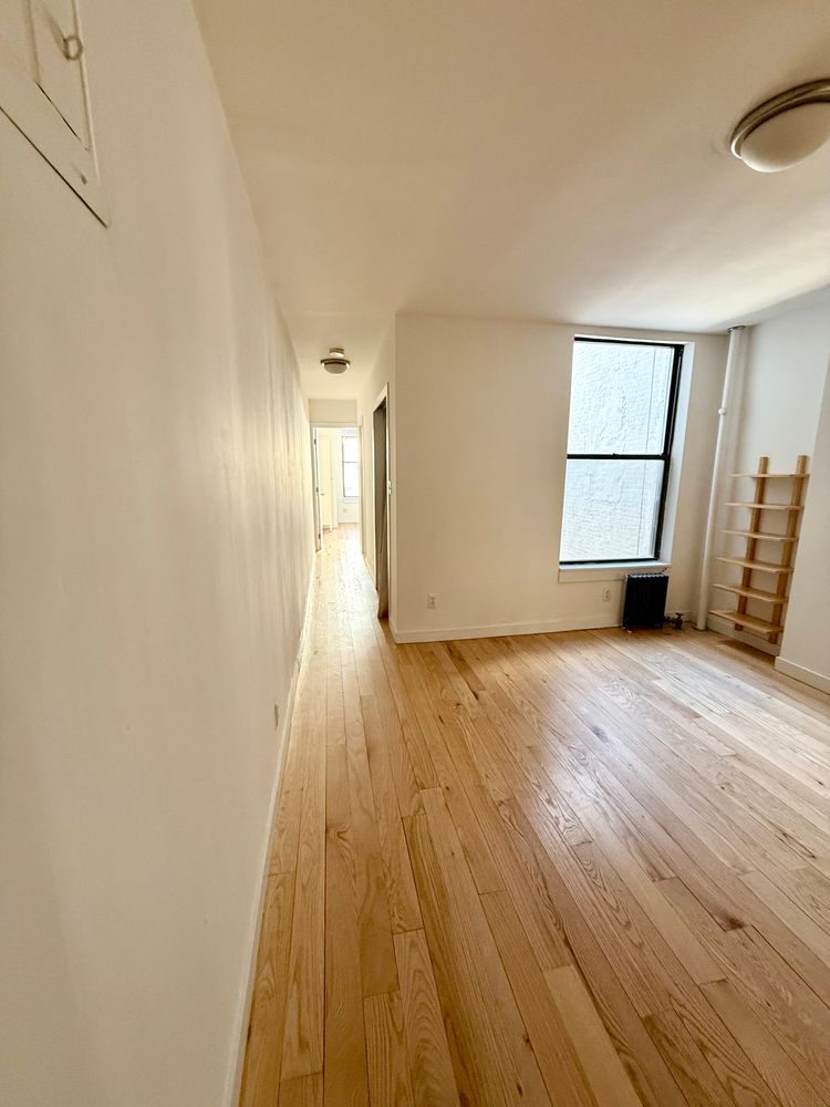 245 West 115th Street, Unit 16 Manhattan, NY 10026 - Photo 4 of 10 a view of empty room with wooden floor and fan