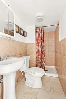 a bathroom with a toilet a sink and a shower