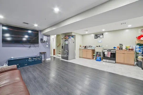 a view of a kitchen with furniture and wooden floor