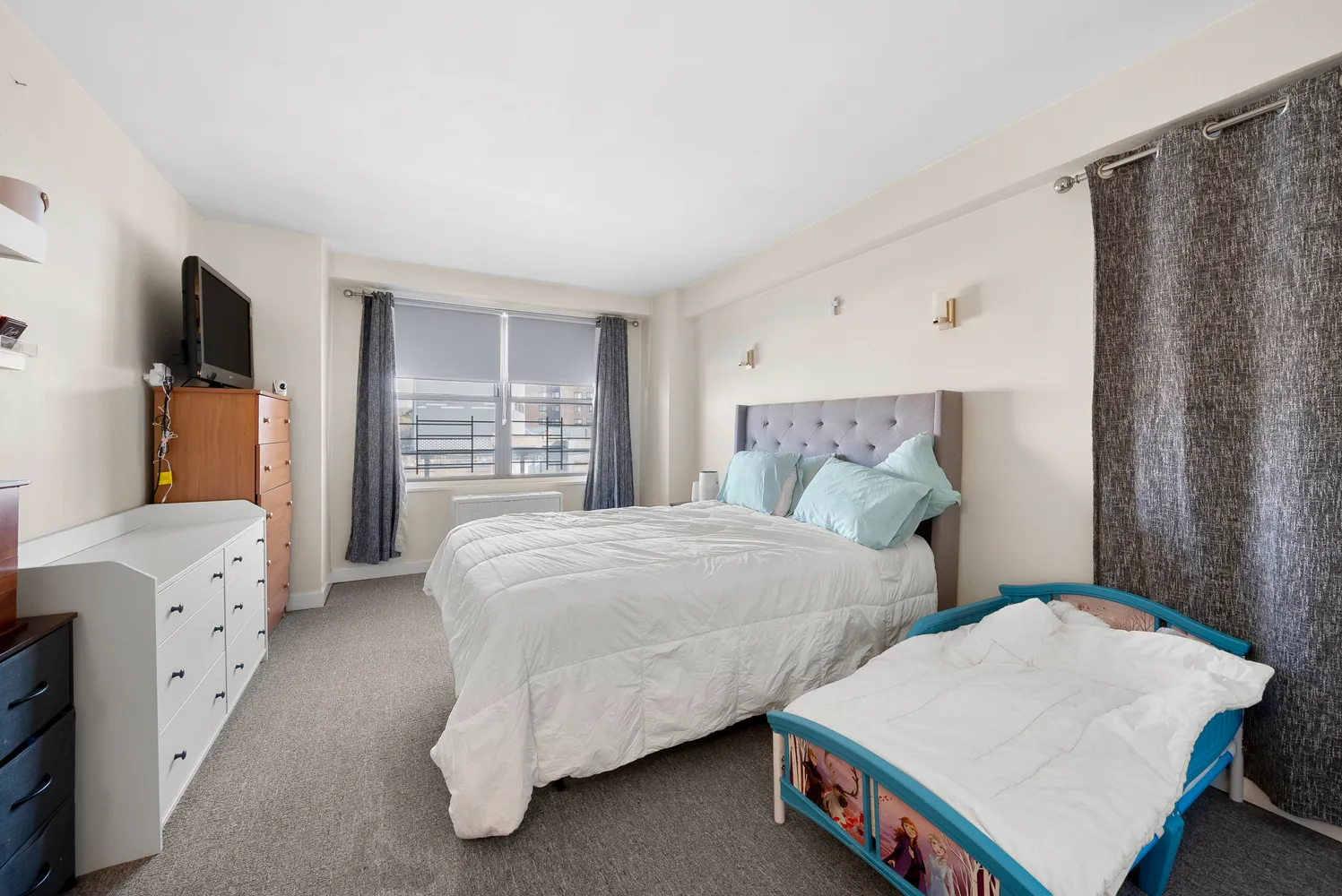 a bedroom with furniture and a wooden floor
