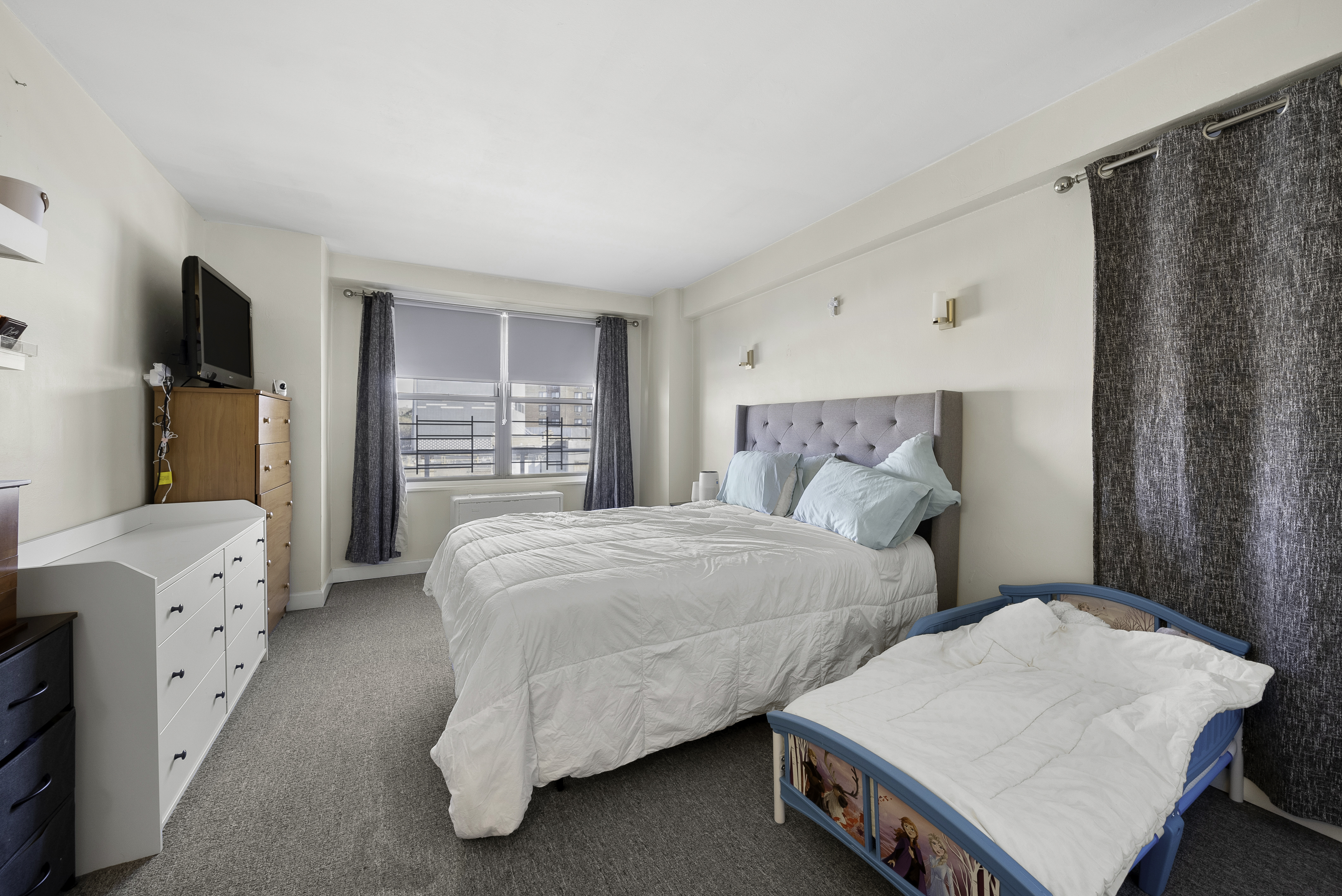 1020 Grand Concourse, Unit 5G Bronx, NY 10451 - Photo 6 of 11 a bedroom with two beds and a window