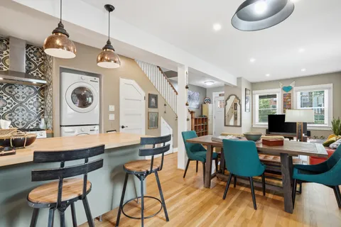 a view of a dining room with furniture a chandelier and wooden floor