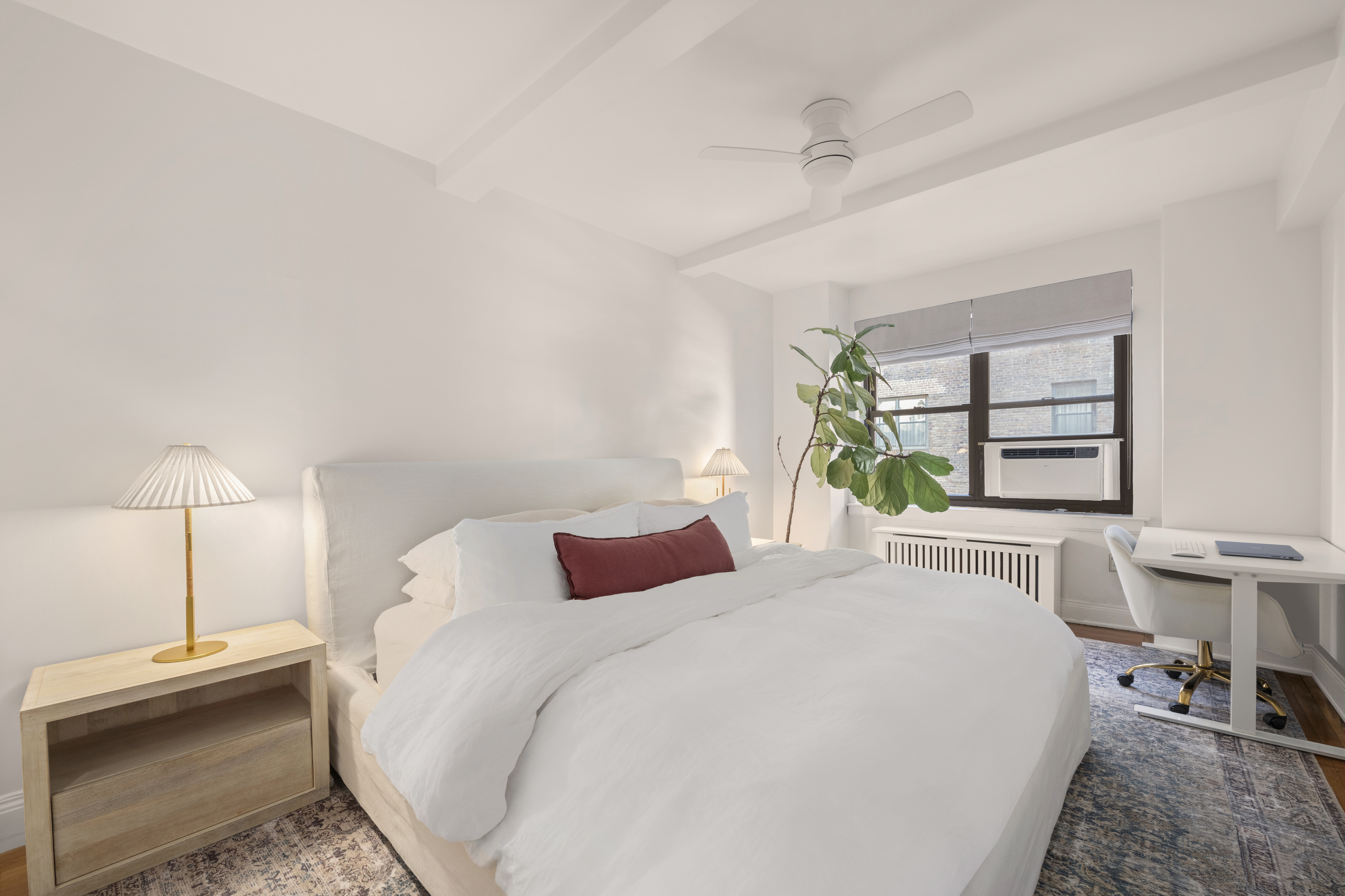 245 East 72nd Street, Unit 6F Manhattan, NY 10021 - Photo 5 of 9 a bedroom with a bed and a window