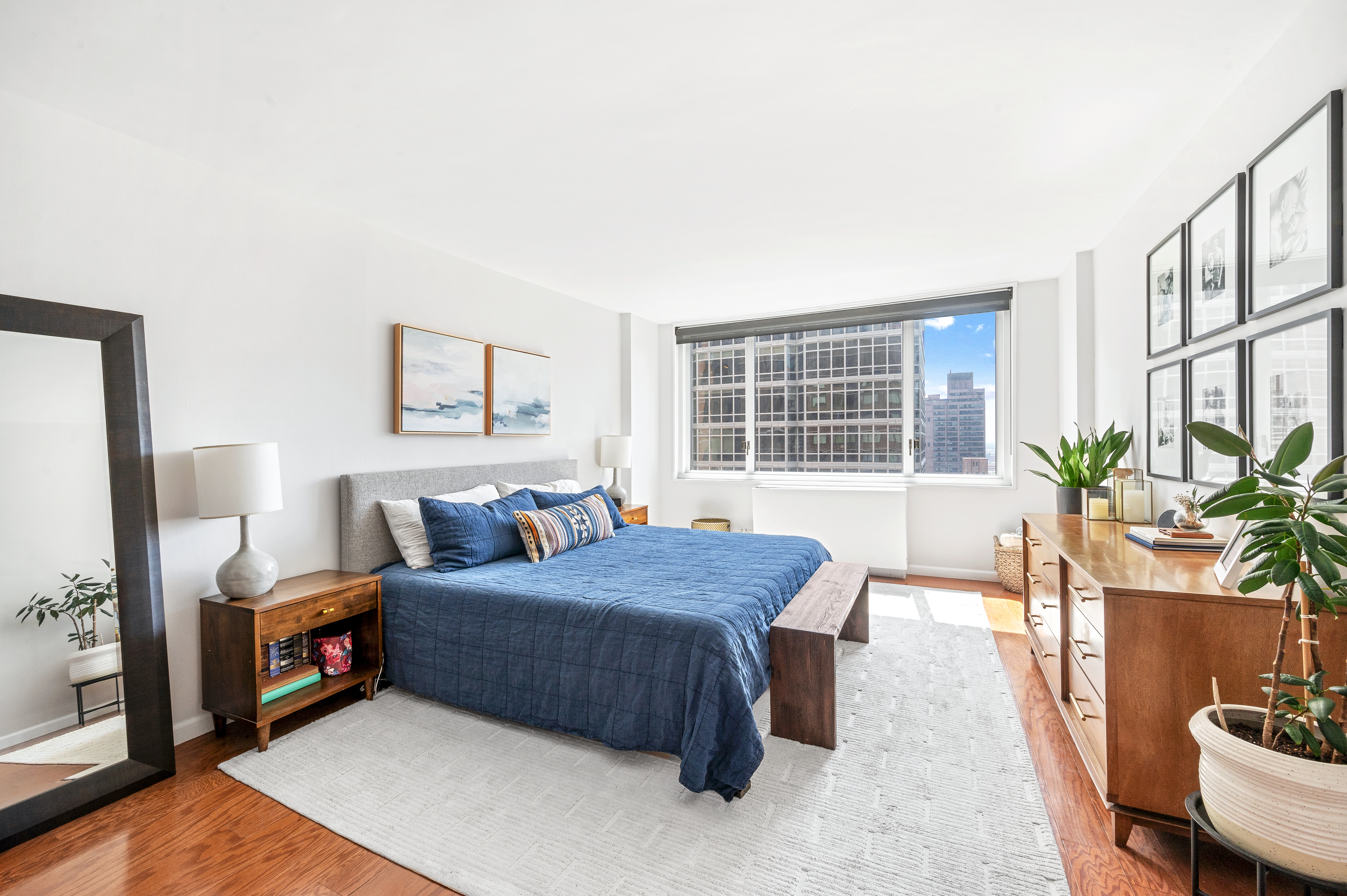 245 East 54th Street, Unit 26JK Manhattan, NY 10022 - Photo 7 of 12 a bedroom with a bed and a potted plant