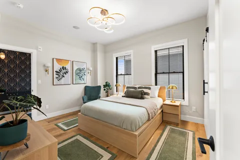 a bedroom with a bed and a chandelier