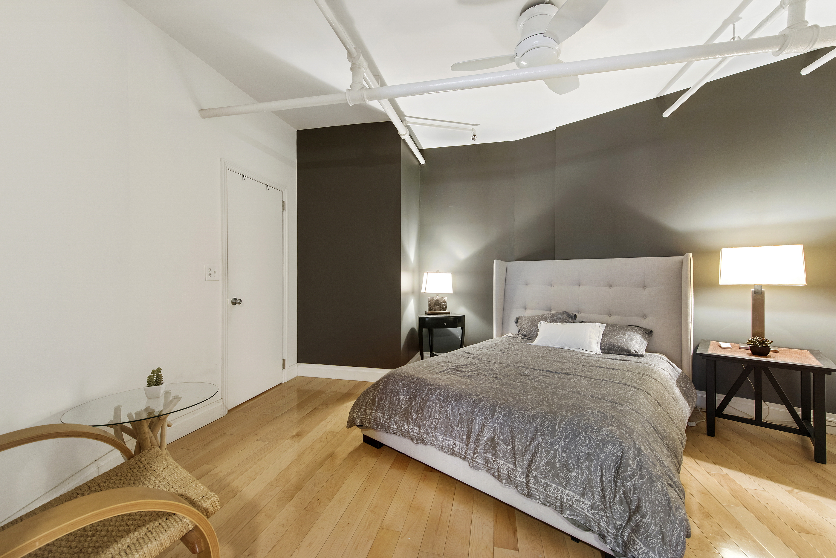 108 Wooster Street, Unit 5B Manhattan, NY 10012 - Photo 5 of 9 a bedroom with a bed and a lamp