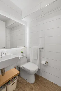 a bathroom with a sink a toilet and mirror