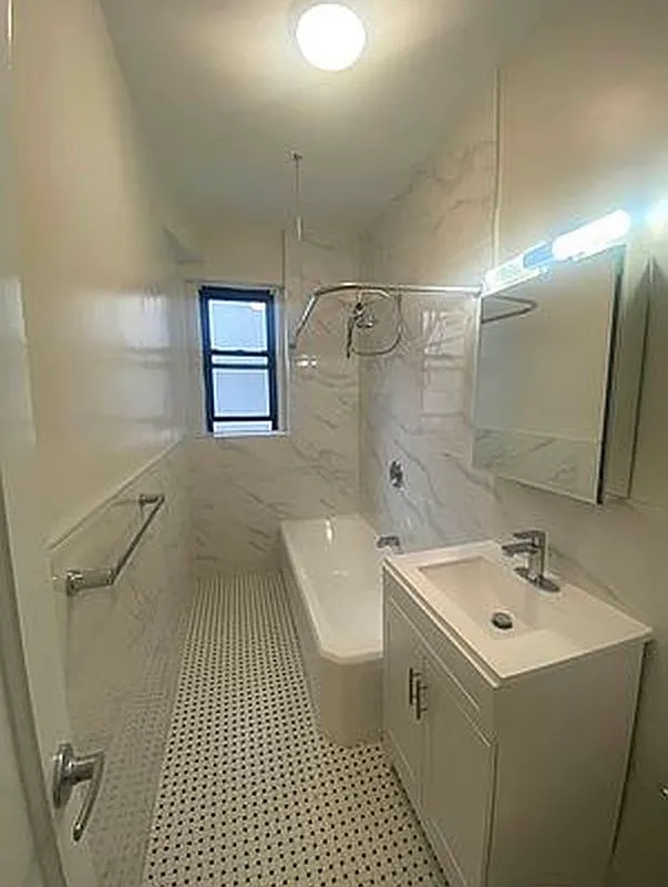 625 Caton Avenue, Unit 4E Brooklyn, NY 11218 - Photo 9 of 12 a bathroom with a sink a toilet a mirror and shower