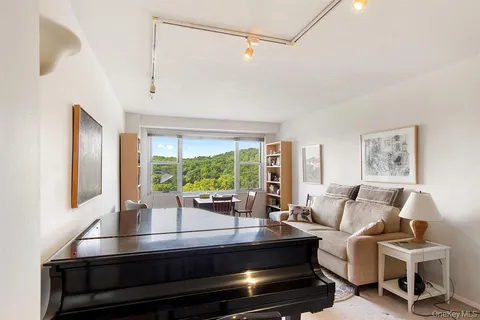 a living room with furniture and a floor to ceiling window