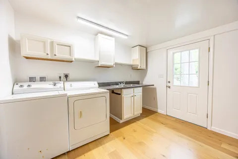a kitchen with a sink cabinets and window