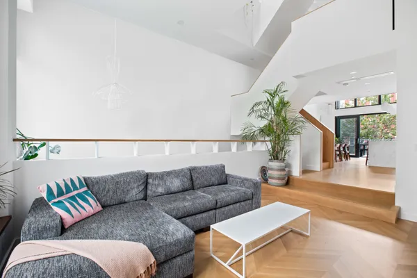 a living room with furniture and a potted plant