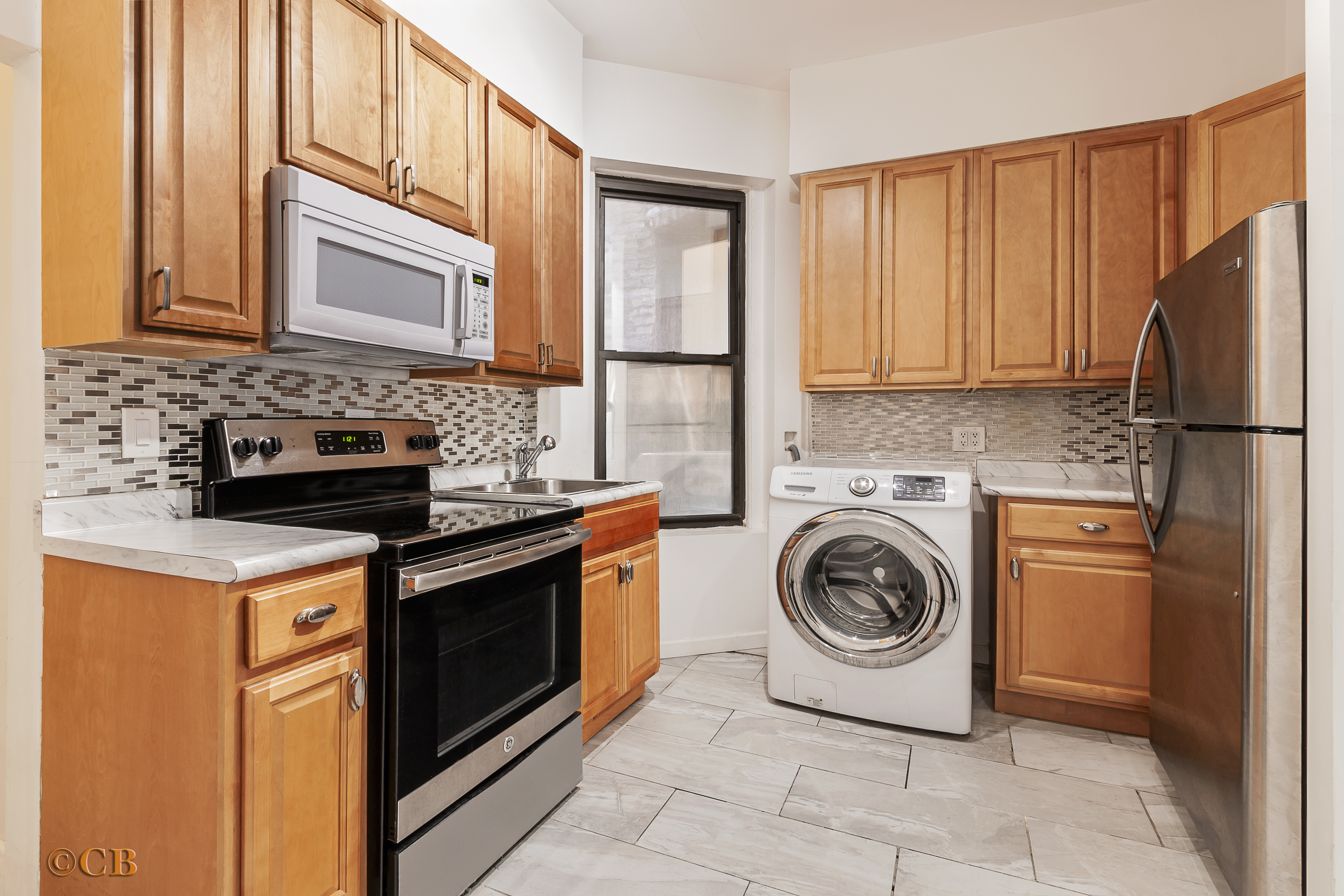 131 Thompson Street, Unit 4C Manhattan, NY 10012 - Photo 4 of 9 a kitchen with a stove sink and cabinets